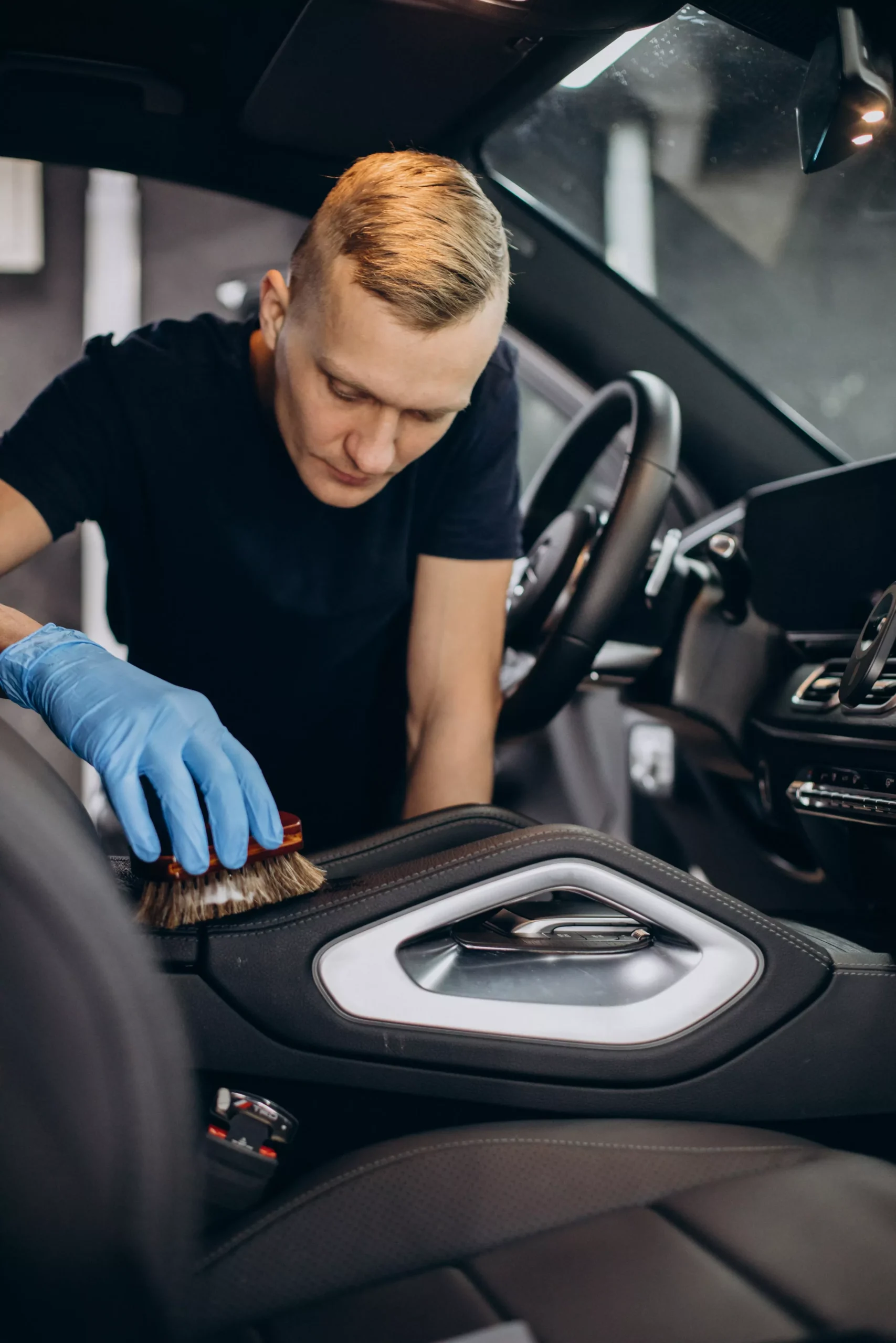 man-car-clean-using-brush-clean-up-all-details-inside-vehicle