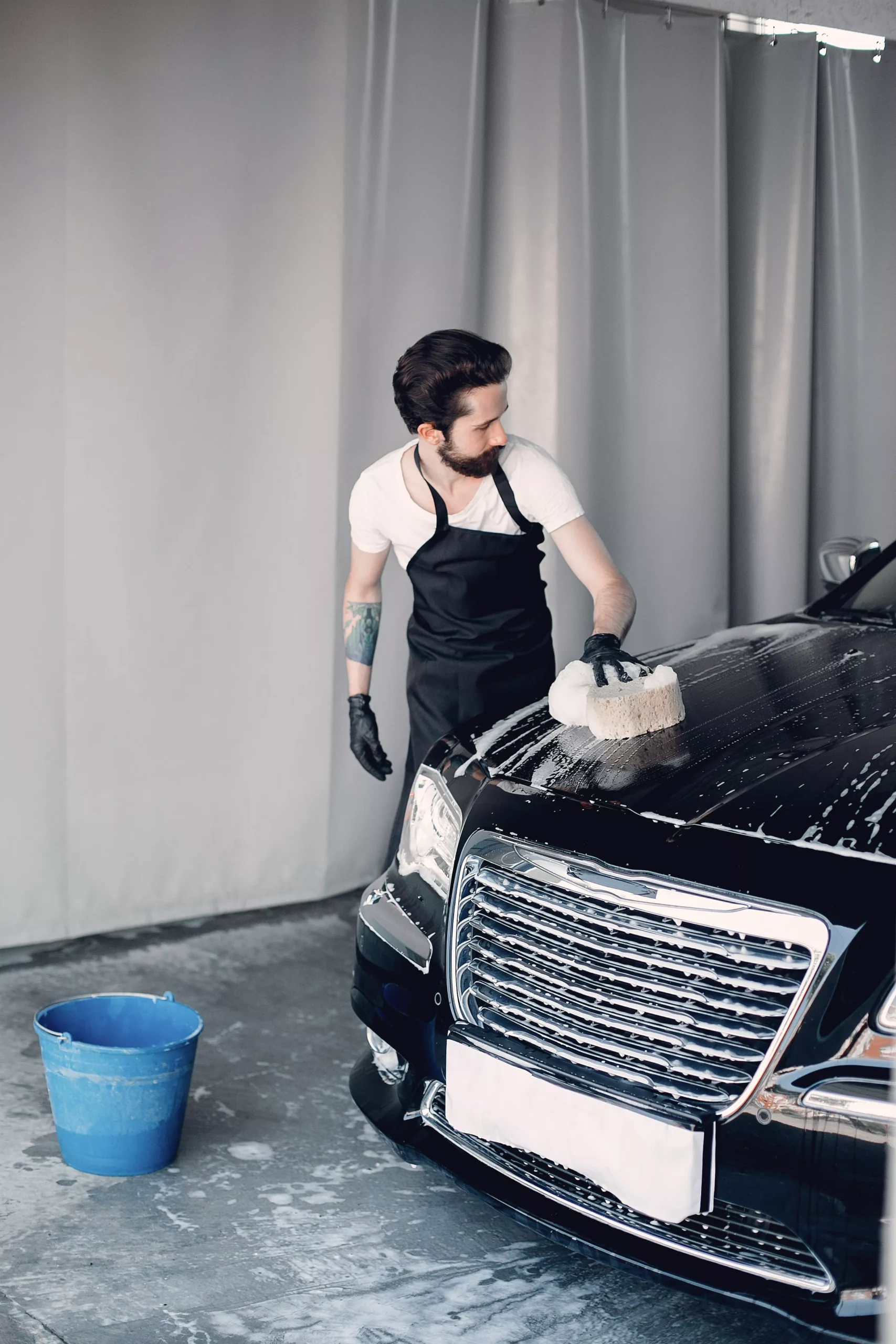 man-washing-his-car-garage